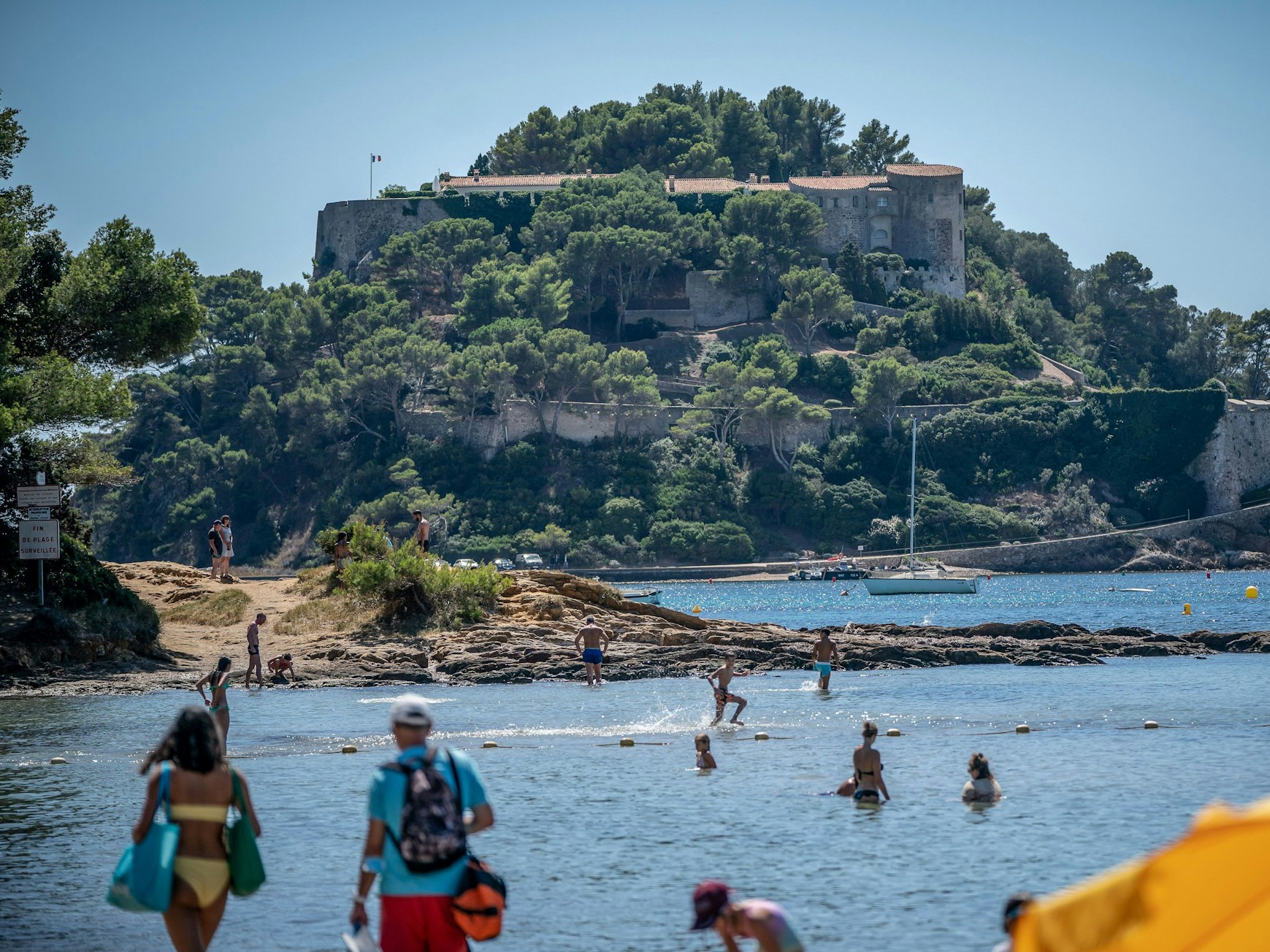 Badegäste schwimmen unterhalb der Sommerresidenz des Staatschefs von Frankreich, Macron, dem Fort de Bregancon am Mittelmeer.