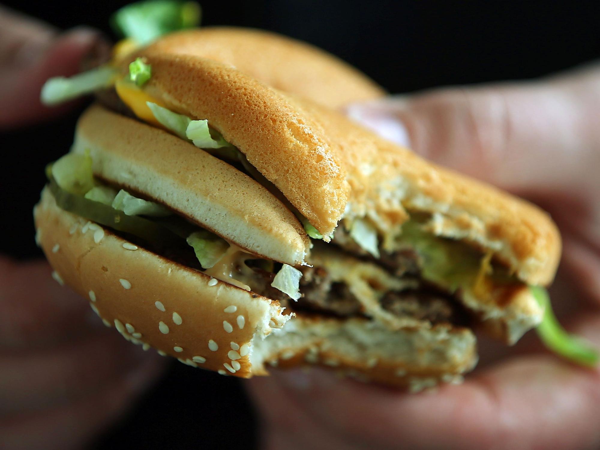 Ein Mann hält in Köln (Nordrhein-Westfalen) einen Big Mac von McDonald's in den Händen, hier im Mai 2015.