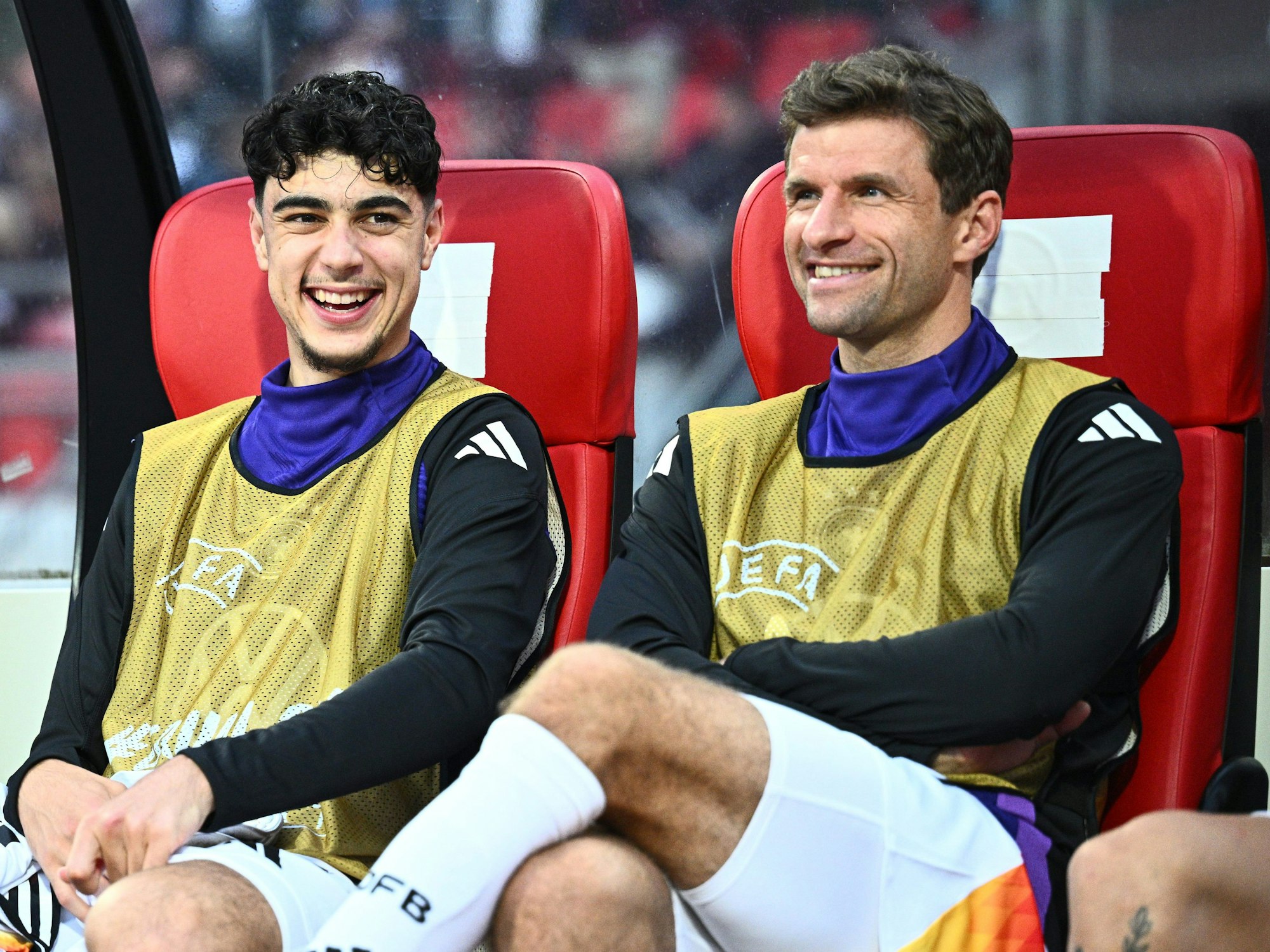 Deutschlands Thomas Müller und Aleksandar Pavlović (l) sitzen auf der Ersatzbank.
