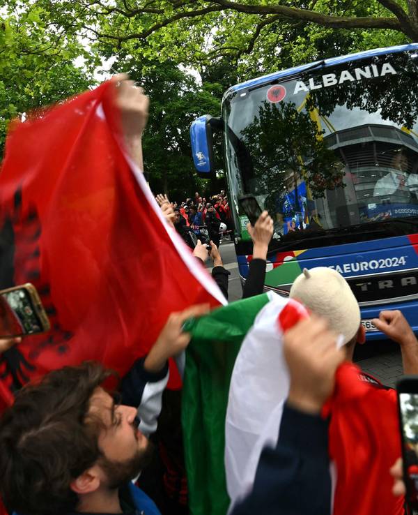 Fans zeigen am 15. Juni 2024 albanische und italienische Flaggen, während der albanische Mannschaftsbus am Stadion ankommt.