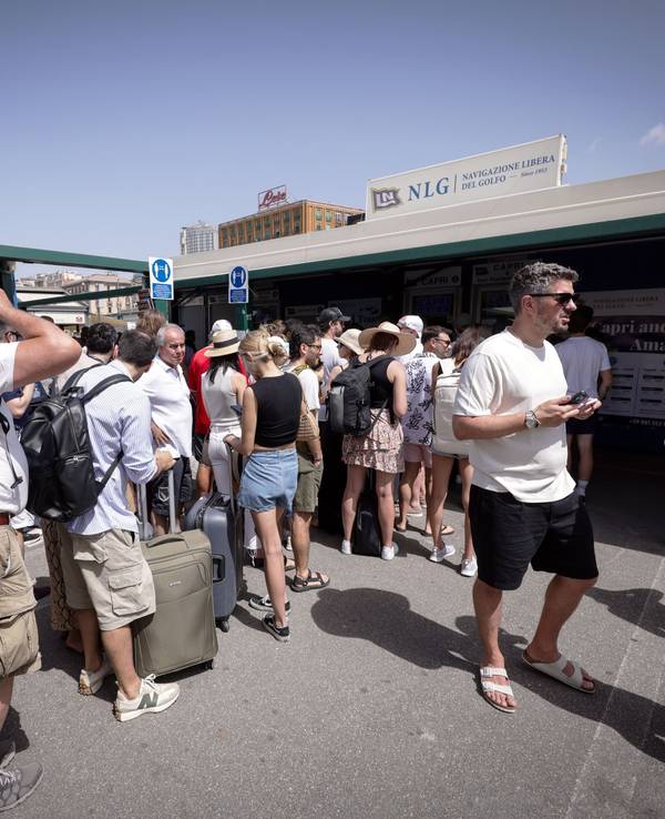Reisende warten am Hafen von Neapel in einer Schlange vor den Ticketschaltern nach Capri. Touristinnen und Touristen durften wegen Problemen mit der Trinkwasserversorgung seit Samstagmorgen (22. Juni 2024) nicht mehr auf der italienischen Mittelmeerinsel an Land gehen. Am Sonntag wurde das Verbot aufgehoben.
