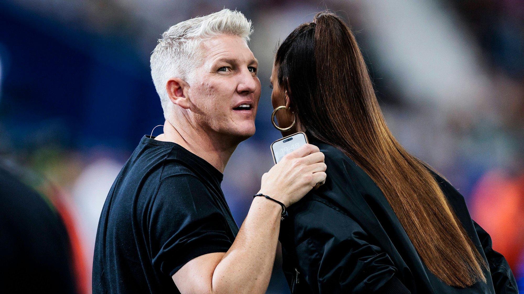 Bastian Schweinsteiger flüstert Esther Sedlaczek etwas ins Ohr.