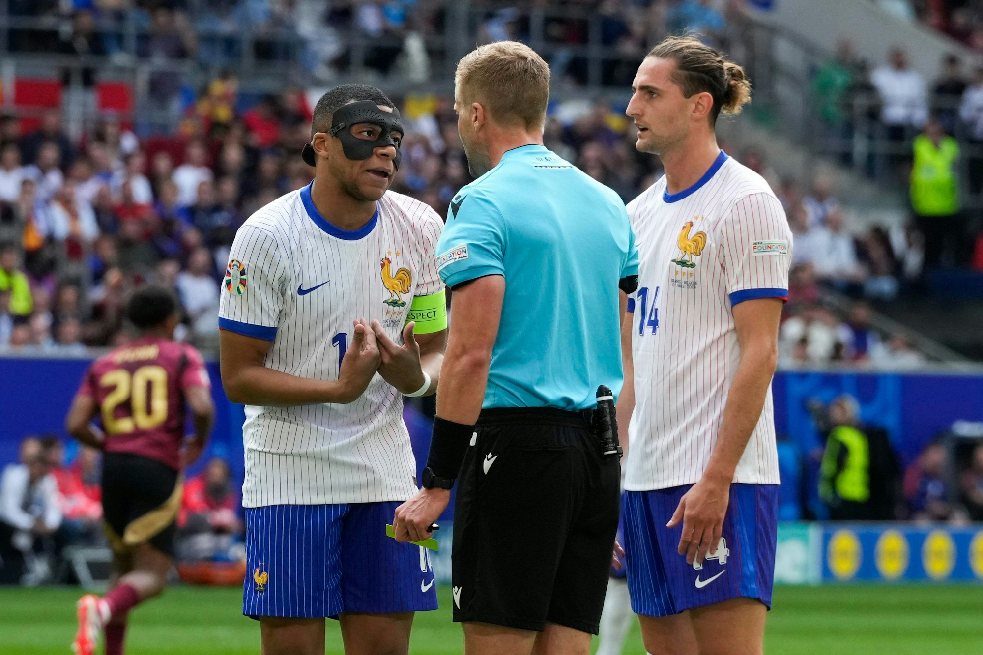 Kylian Mbappé und Adrien Rabiot beim EM-Spiel zwischen Frankreich und Belgien im Gespräch mit Schiedsrichter Glenn Nyberg.