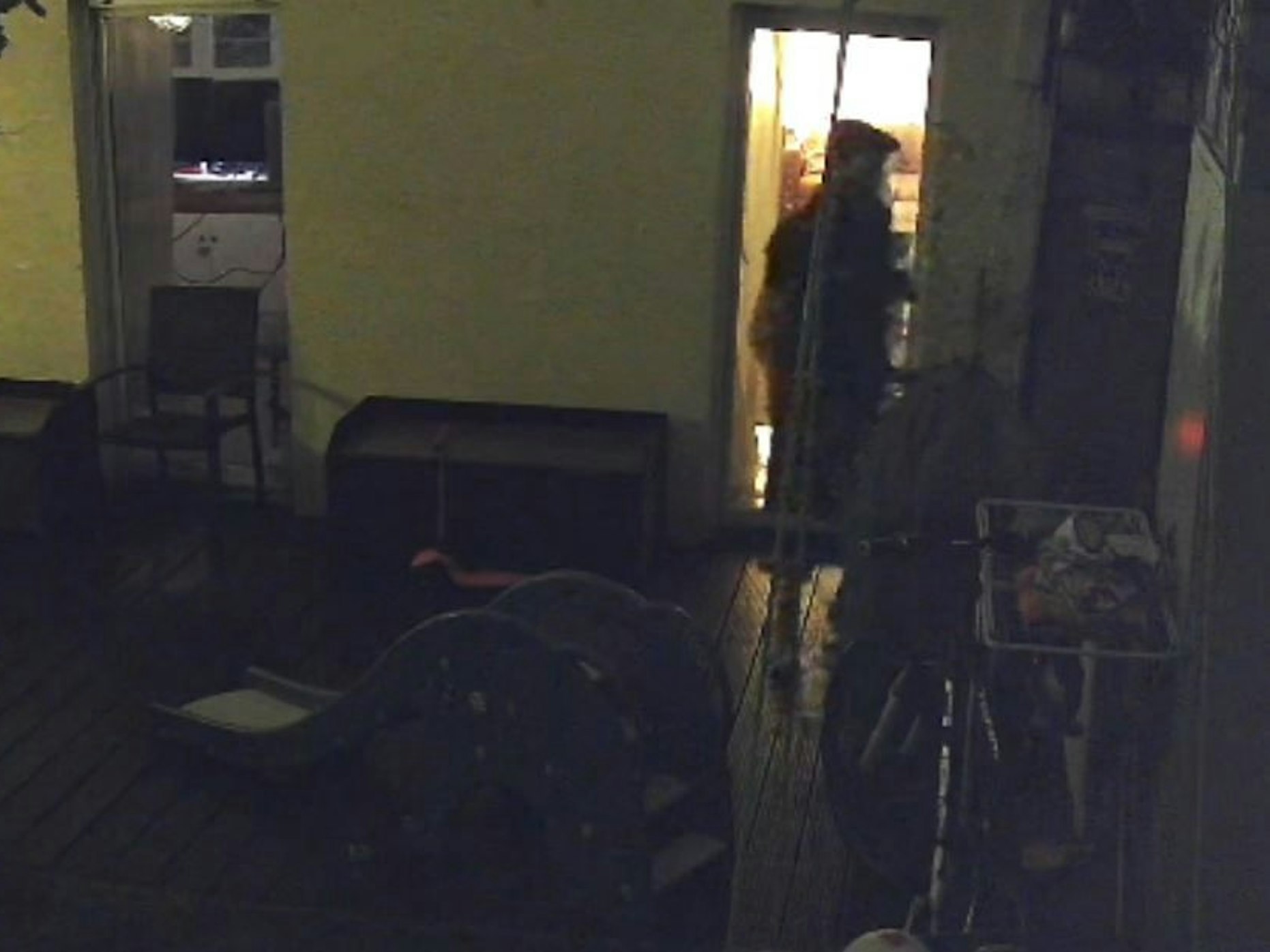 Ein Mann steht im Dunkeln auf einer Terrasse.