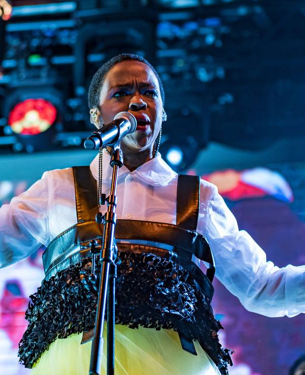 Lauryn Hill singt auf einer Bühne.