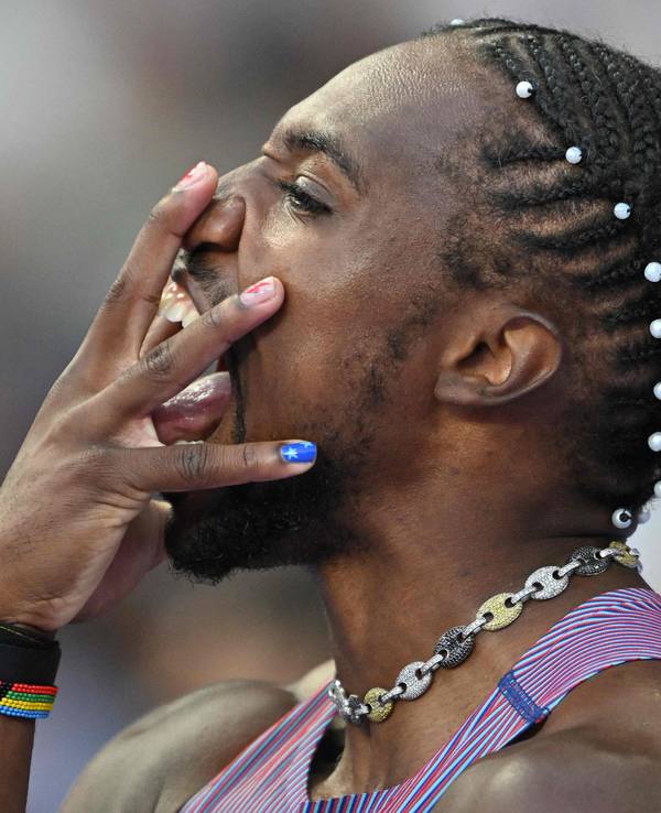 Noah Lyles hält sich vor dem Rennen die Hand vors Gesicht.