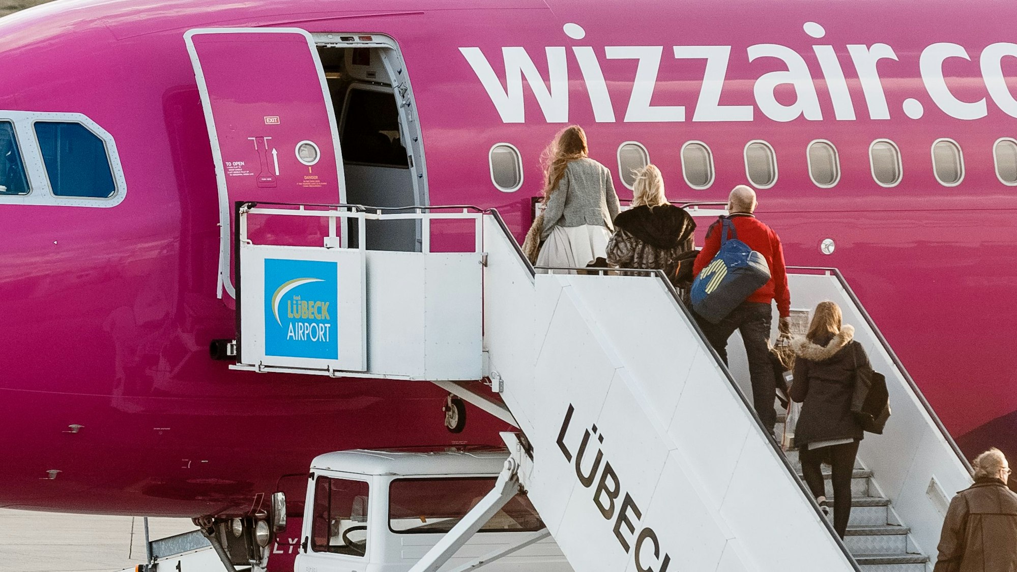 Passagiere besteigen am 21. Dezember 2015 in Lübeck (Schleswig-Holstein) auf dem Flughafen Blankensee ein Flugzeug der Fluglinie WizzAir.