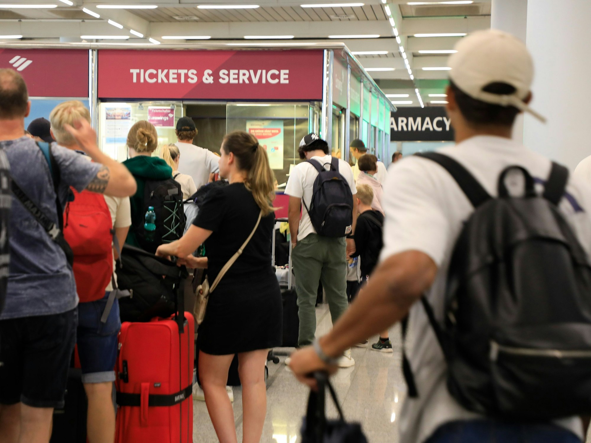 Reisende stehen im Flughafen von Palma de Mallorca Schlange. Ein heftiges Unwetter im spanischen Mittelmeerraum brachte den Flugverkehr auch auf Mallorca durcheinander. Gestern wurden 44 Flüge bis zum Nachmittag wetterbedingt gestrichen.