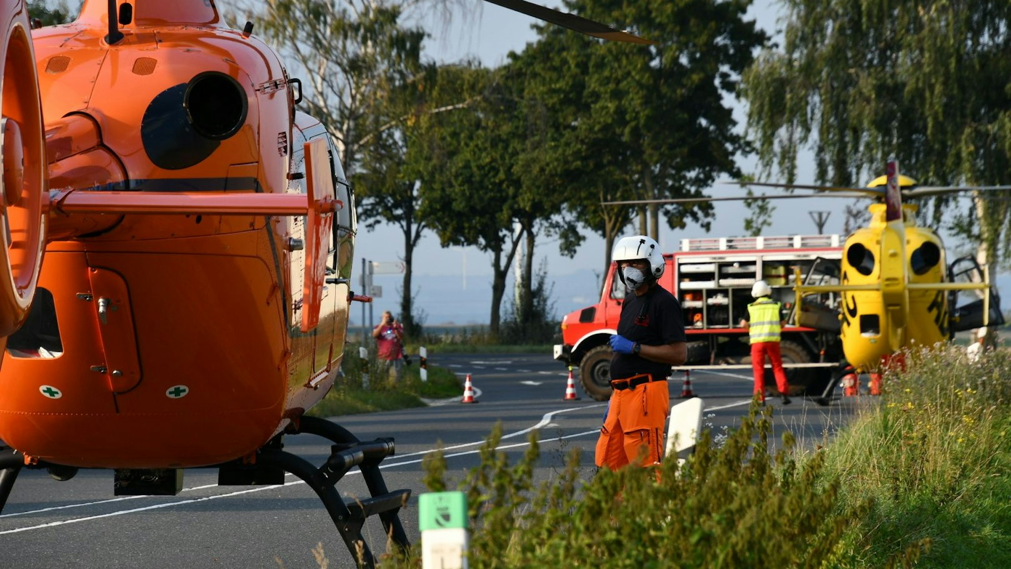 Hubschrauber und Rettungsdienst stehen nach einem Unfall an einer Unfallstelle.