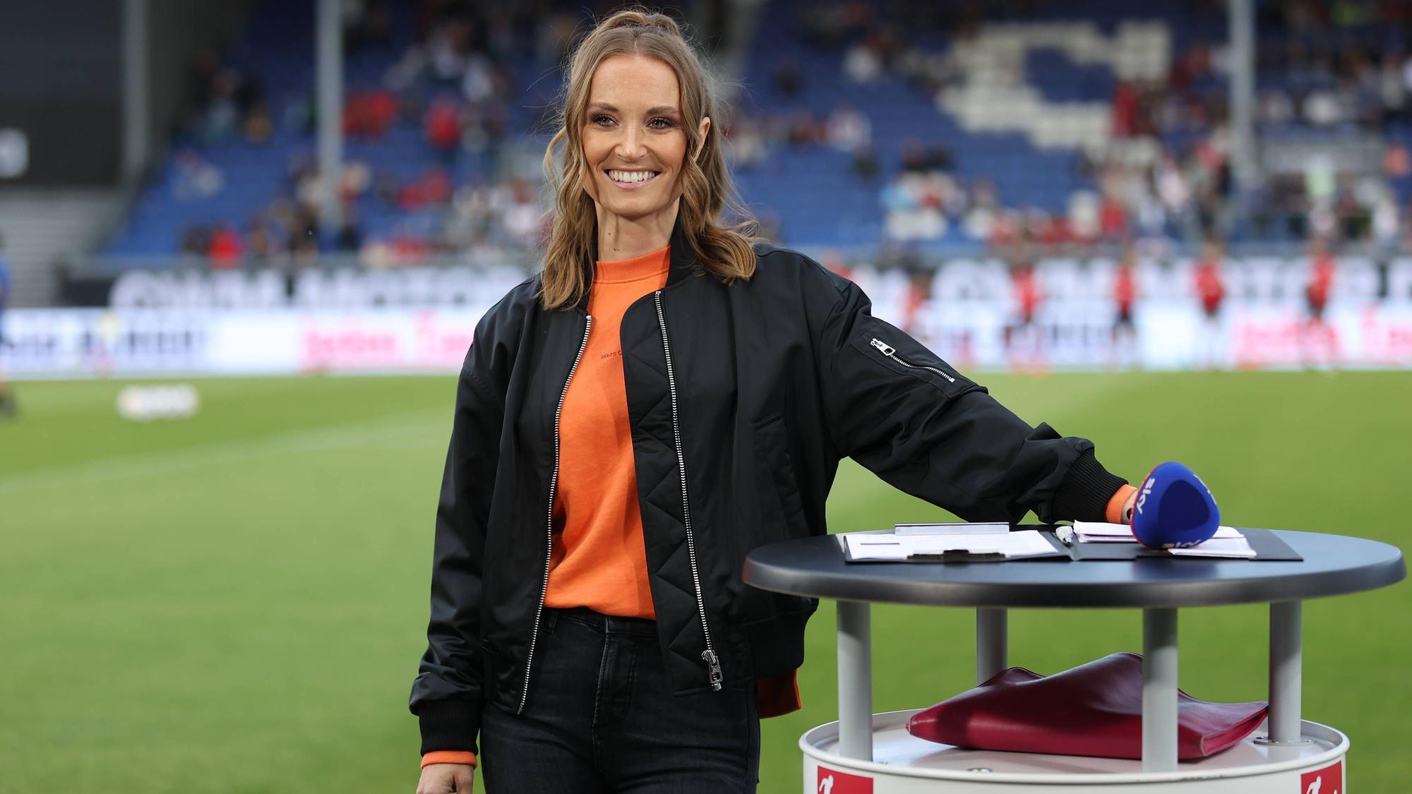 Nele Schenker steht vor dem Relegationsspiel zwischen Wehen Wiesbaden und Jahn Regensburg an ihrem Moderationstisch.