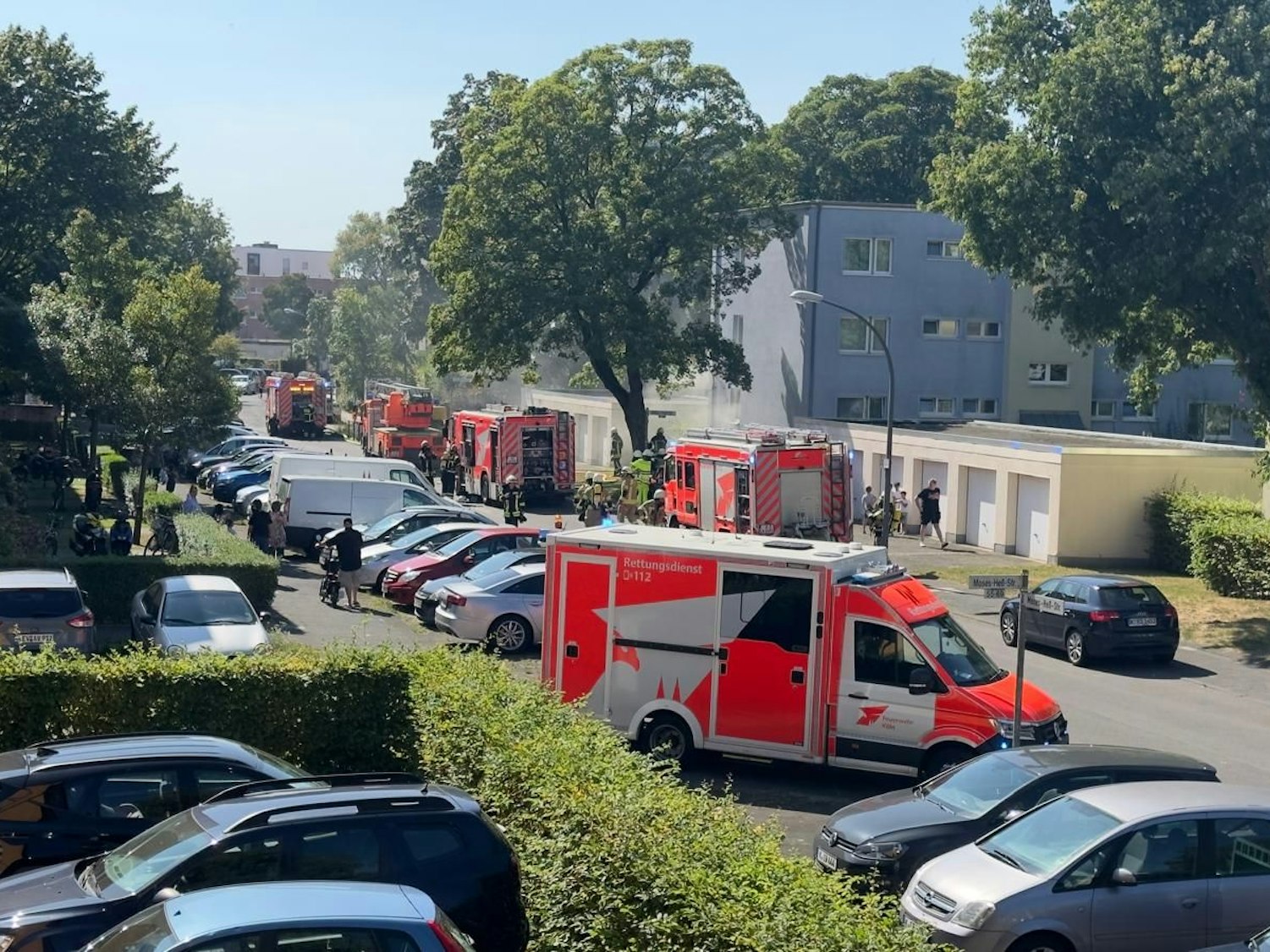 Rettungswagen und Feuerwehrfahrzeuge stehen bei einem Einsatz auf einer Straße.