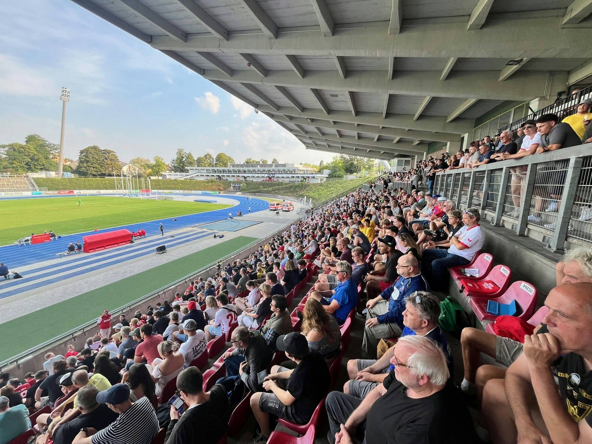 Fans sitzen auf der Tribüne im Sportpark Nord.