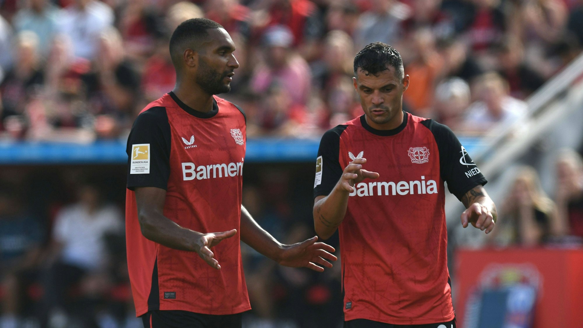Jonathan Tah und Granit Xhaka im Spiel von Bayer Leverkusen im Gespräch.