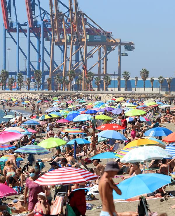 Badegäste und Touristen genießen einen Tag am Strand von La Malagueta.