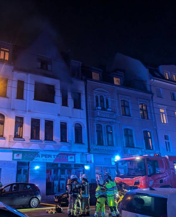 Feuerwehr steht mit großen Wagen und vielen Einsatzkräften vor einem Gebäude auf der Zülpicher Straße in Köln.