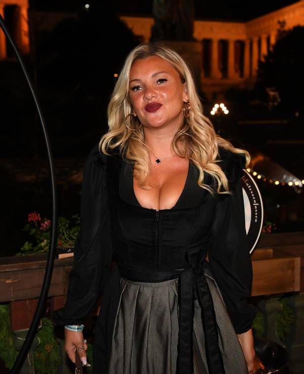 Der TV-Star Evelyn Burdecki steht dem Balkon des Käferzelt beim Almauftrieb auf der Wiesn.