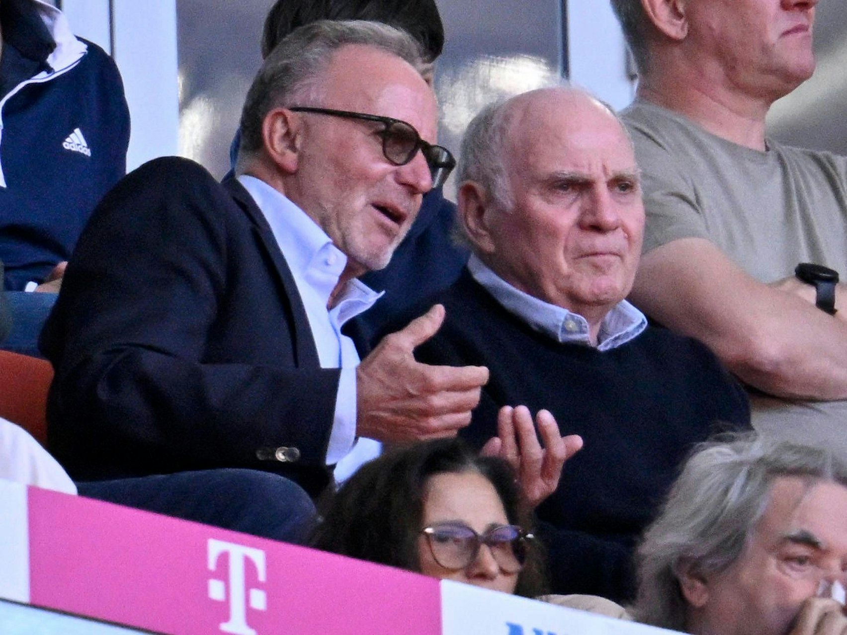Karl-Heinz Rummenigge und Uli Hoeneß diskutieren während eines Spiels auf der Tribüne.