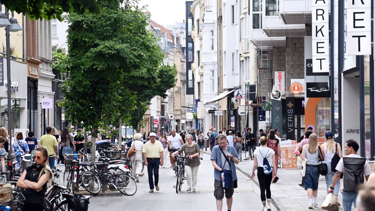 Menschen gehen über die Ehrenstraße in Köln. Es ist eine der beliebtesten Shoppingmeilen der Stadt.