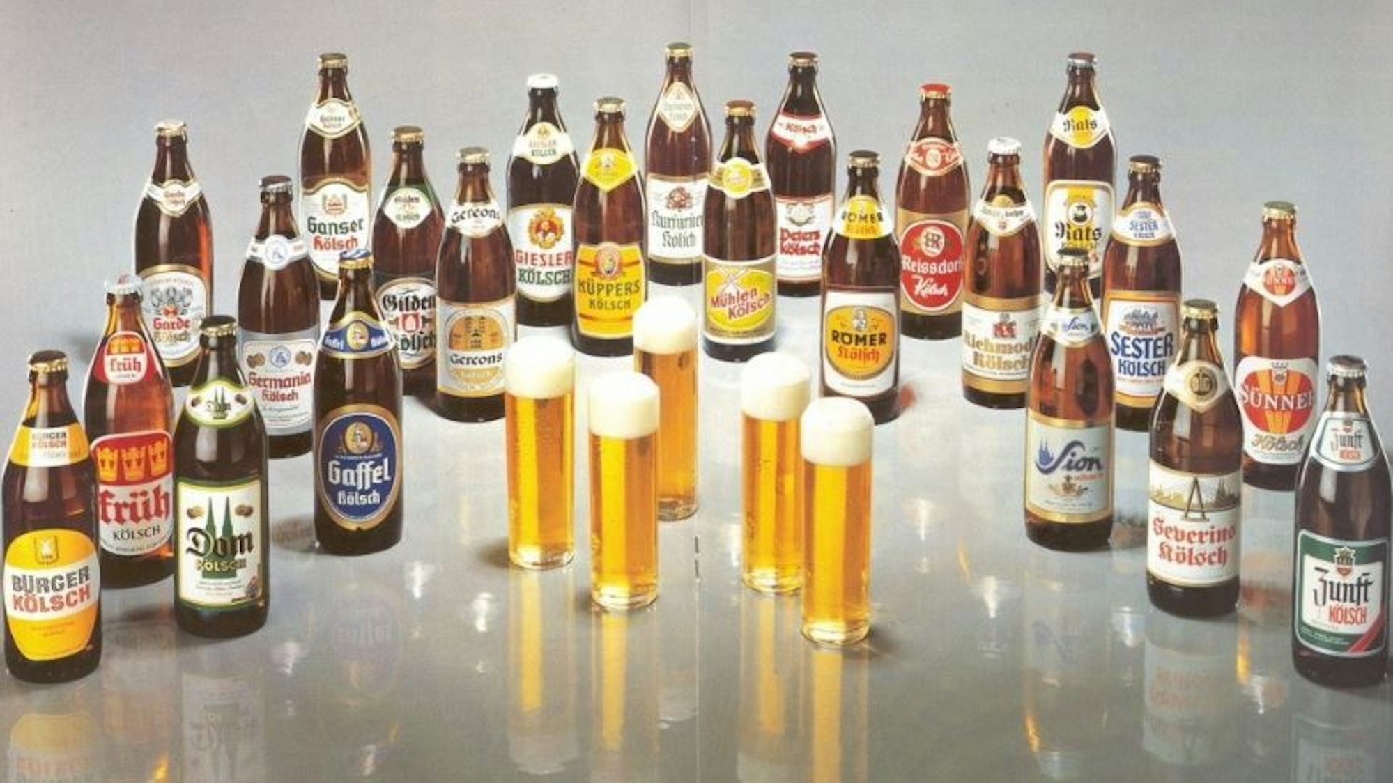 Mehrere alte Kölsch-Flaschen und die Etiketten