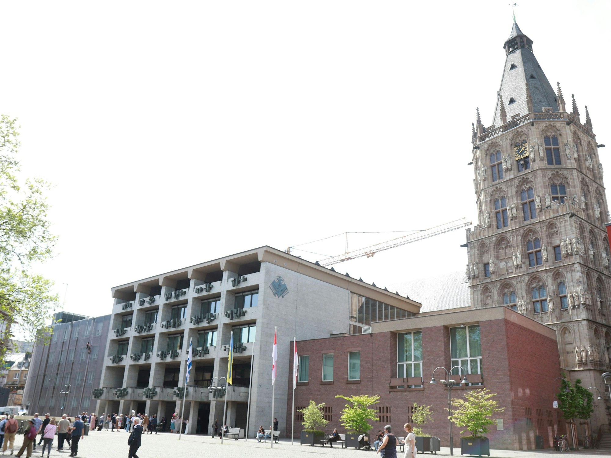Das Historische Rathaus am Alter Markt in Köln. Davor stehen einige Passantinnen und Passanten.