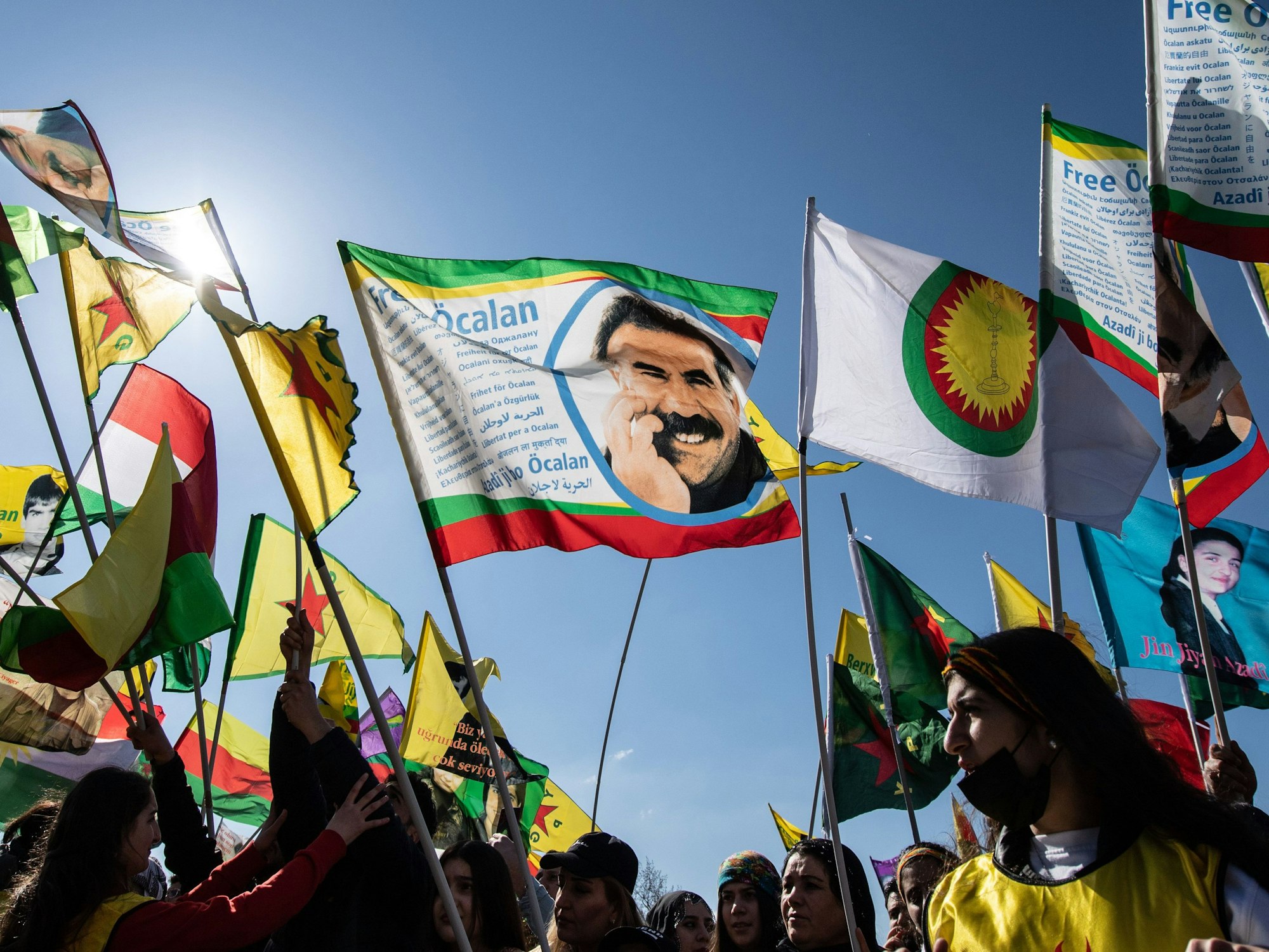 Ein Mann zeigt auf der kurdischen Newroz-Feier in Frankfurt eine Fahne mit dem Bild des inhaftierten Kurdenführers Abdullah Öcalan.