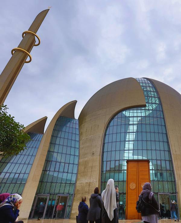 Menschen stehen vor der Zentralmoschee in Köln-Ehrenfeld.