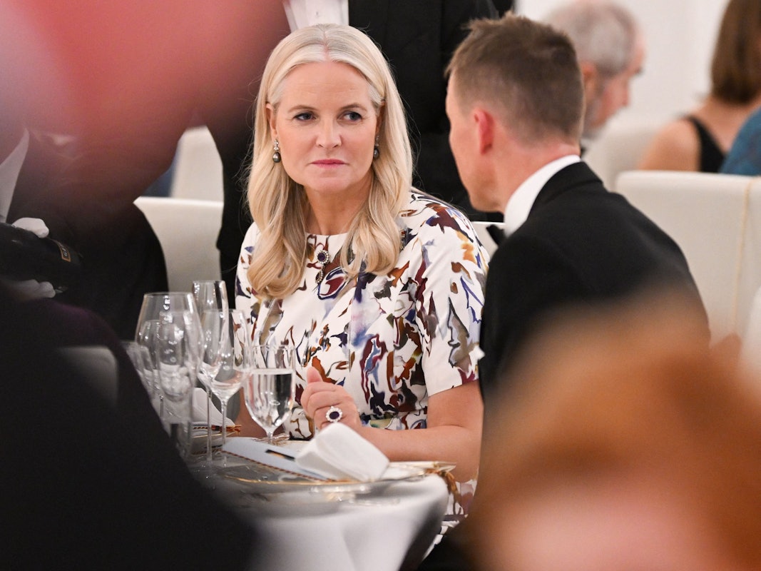 Norwegens Kronprinzessin Mette-Marit unterhält sich mit einem Mann