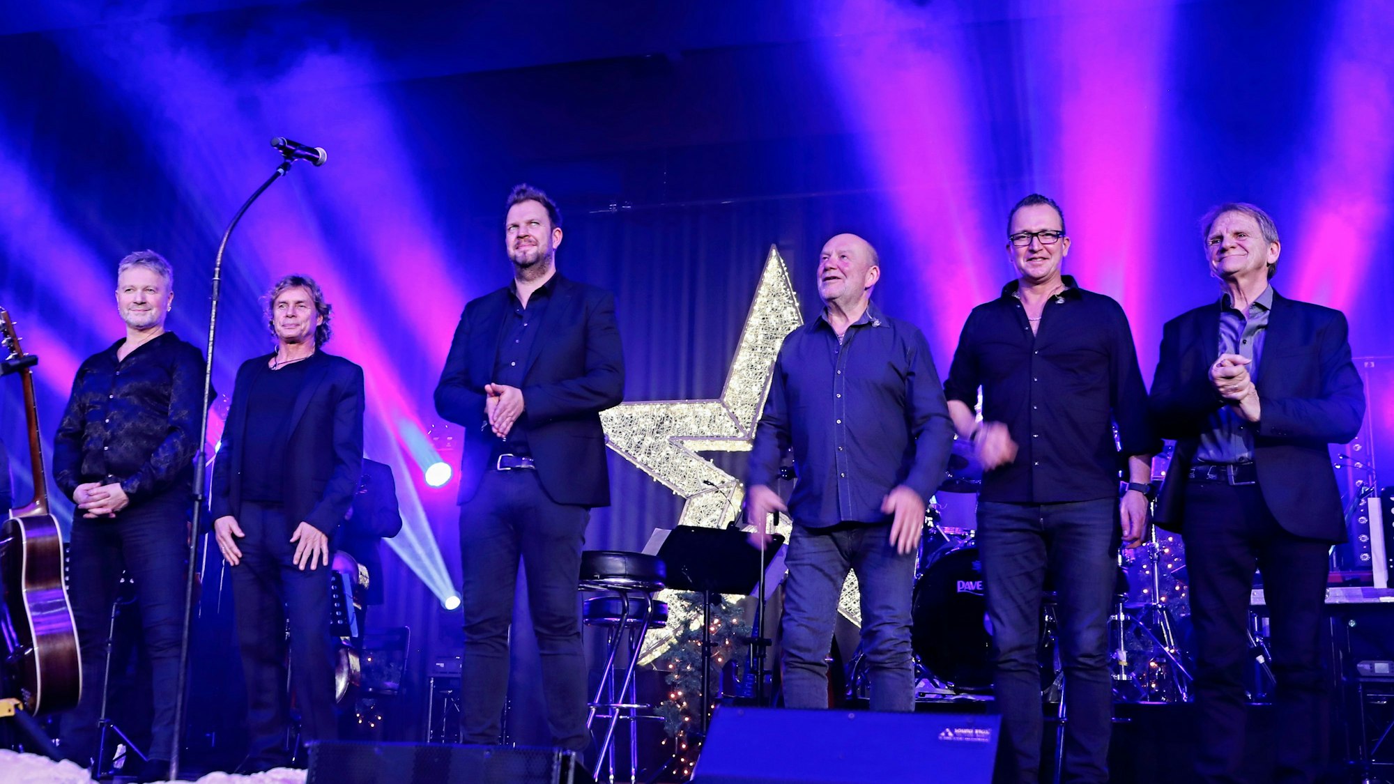 Die Band Paveier steht auf einer Bühne.