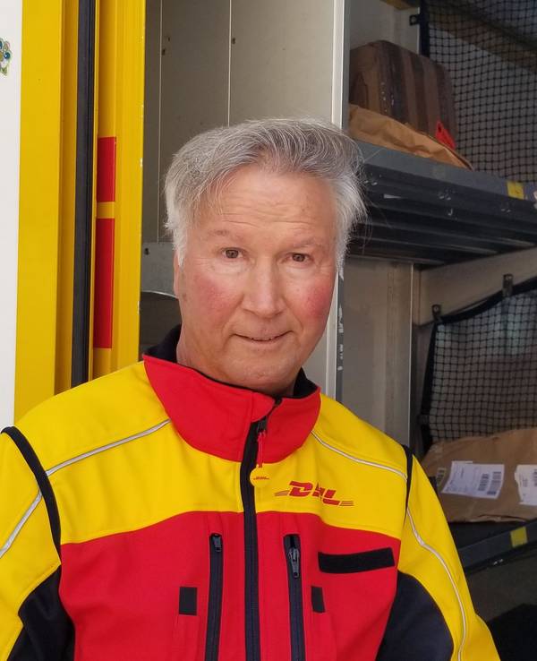 Ein DHL-Zusteller bei der Arbeit in Köln