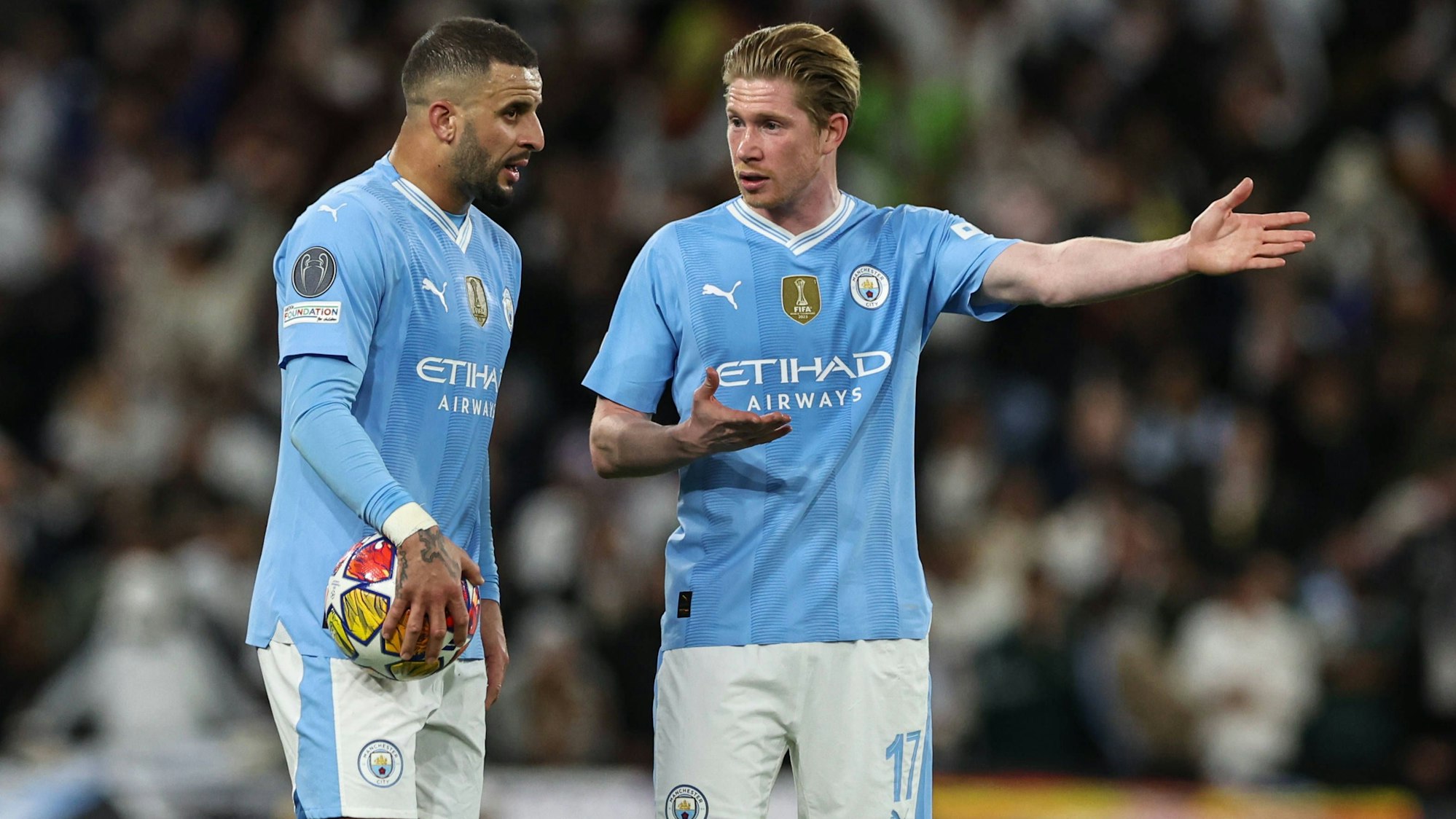 Kevin De Bruyne und Kyle Walker diskutieren im Trikot von Manchester City.