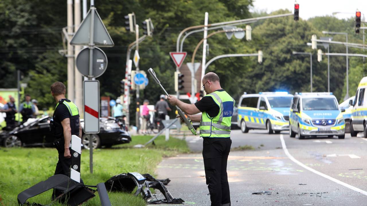 Einsatzkräfte der Polizei stehen an einer Unfallstelle und bewerten die Lage.