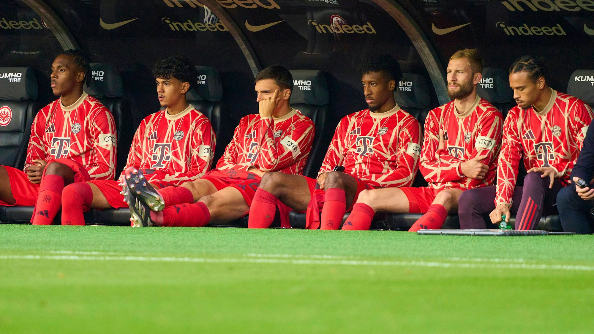 Adam Aznou (2.v.l.) und mehrere Teamkollegen verfolgen das Spielgeschehen von der Ersatzbank.