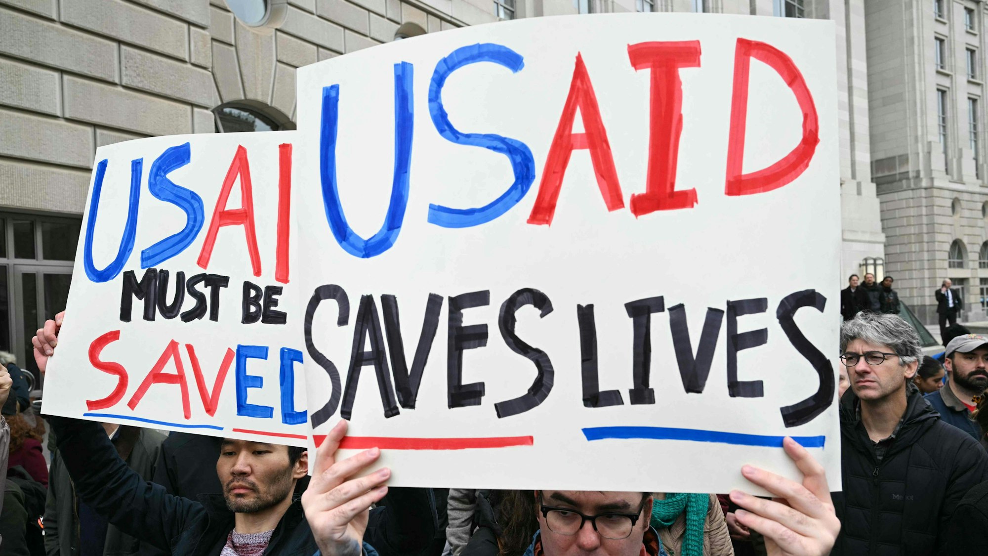 Menschen protestieren vor dem Sitz von USAID gegen die Maßnahmen von Trump und Musk.