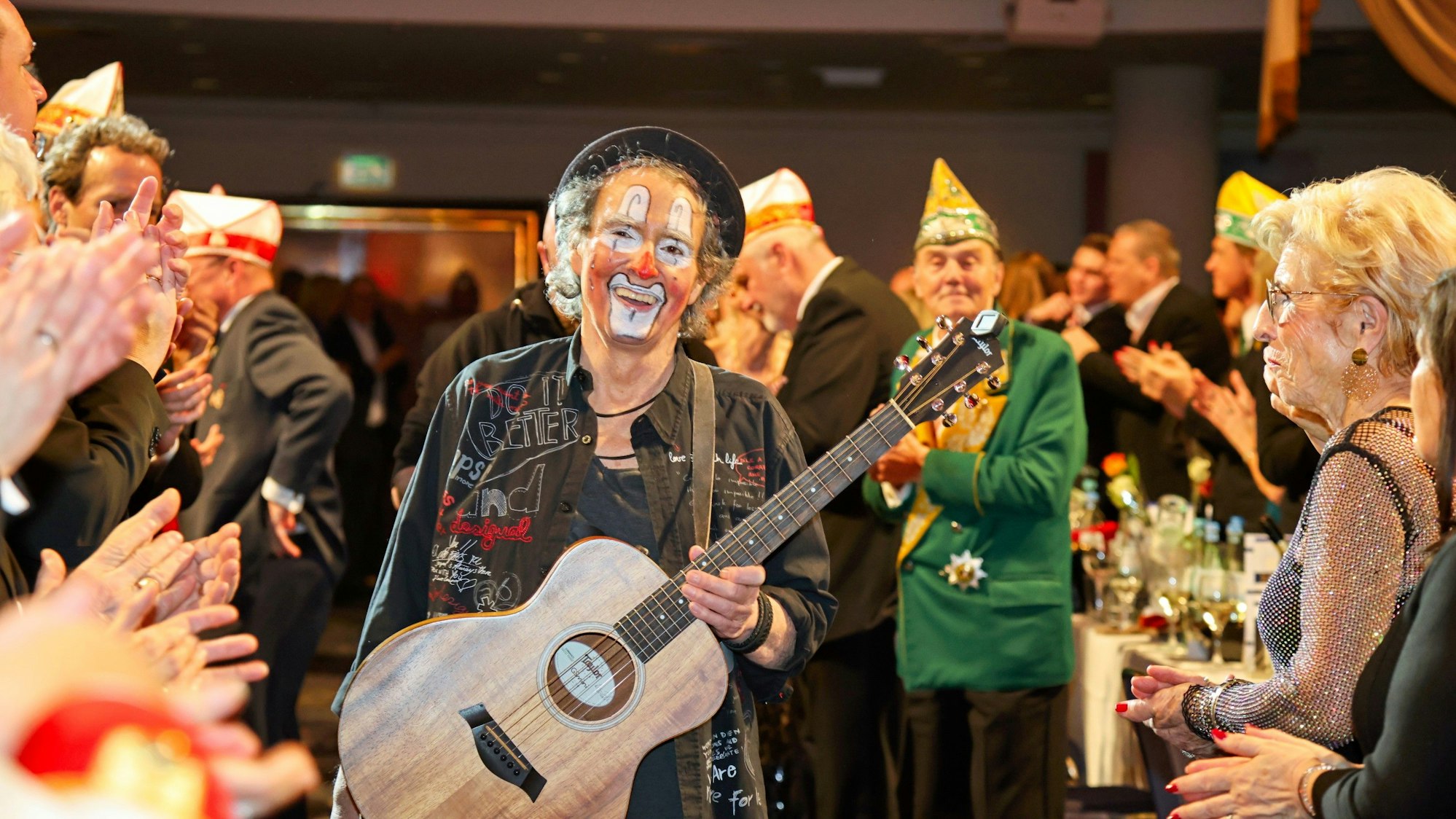 Peter Horn geht mit seiner Gitarre zur Bühne.
