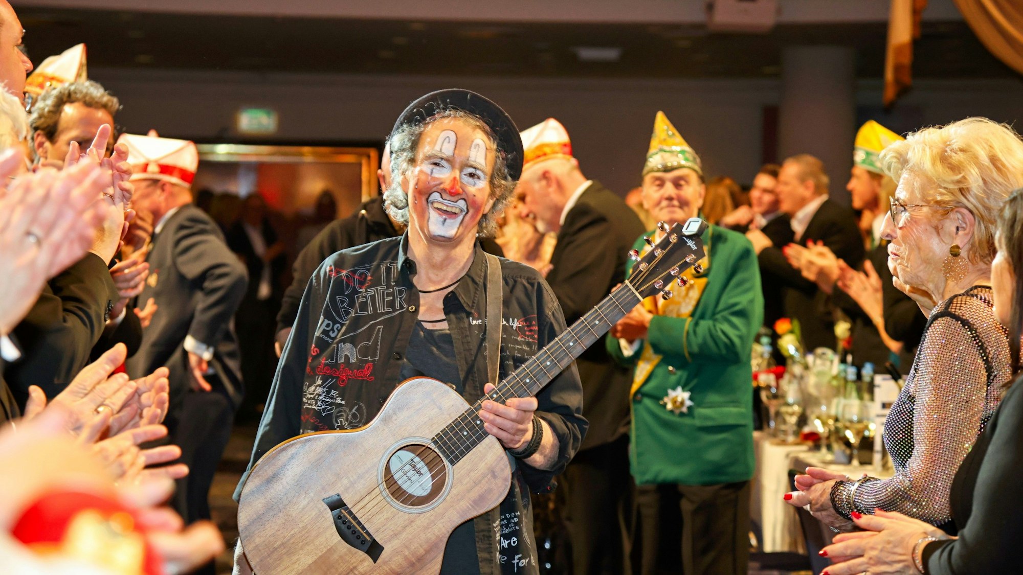 Peter Horn geht mit seiner Gitarre zur Bühne.