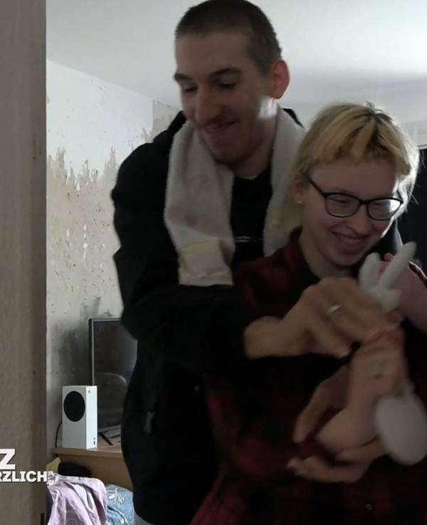 Maik liegt Jasmin im Arm.