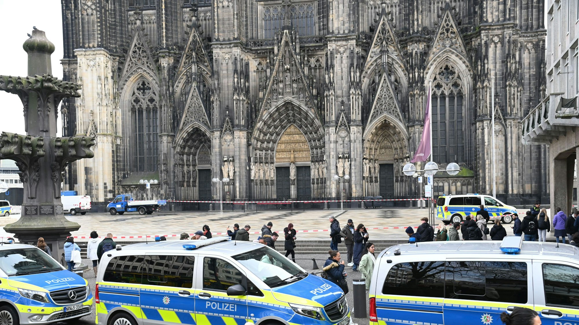 Die Polizei hat den Platz vor dem Dom abgesperrt, dort stehen mehrere Polizeifahrzeuge.
