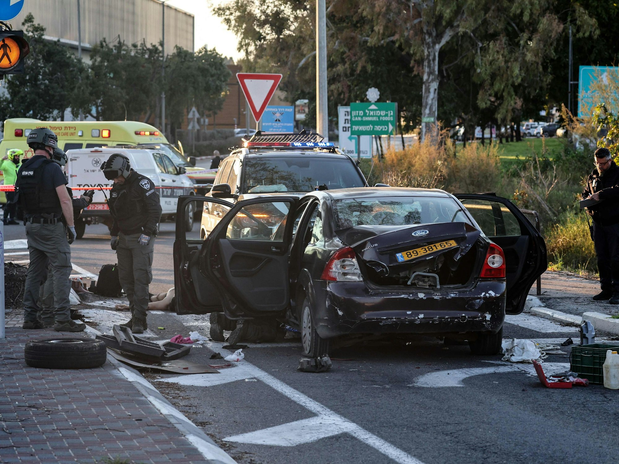 Israeli security forces inspect a vehicle that reportedly rammed into pedestrians at the Karkur junction south of the city of Haifa in northern Israel on February 27, 2025, Israel's first responders, Magen David Adom, said their team was treating seven casualties at the site of the incident, including one in serious condition. (Photo by Jack GUEZ / AFP)