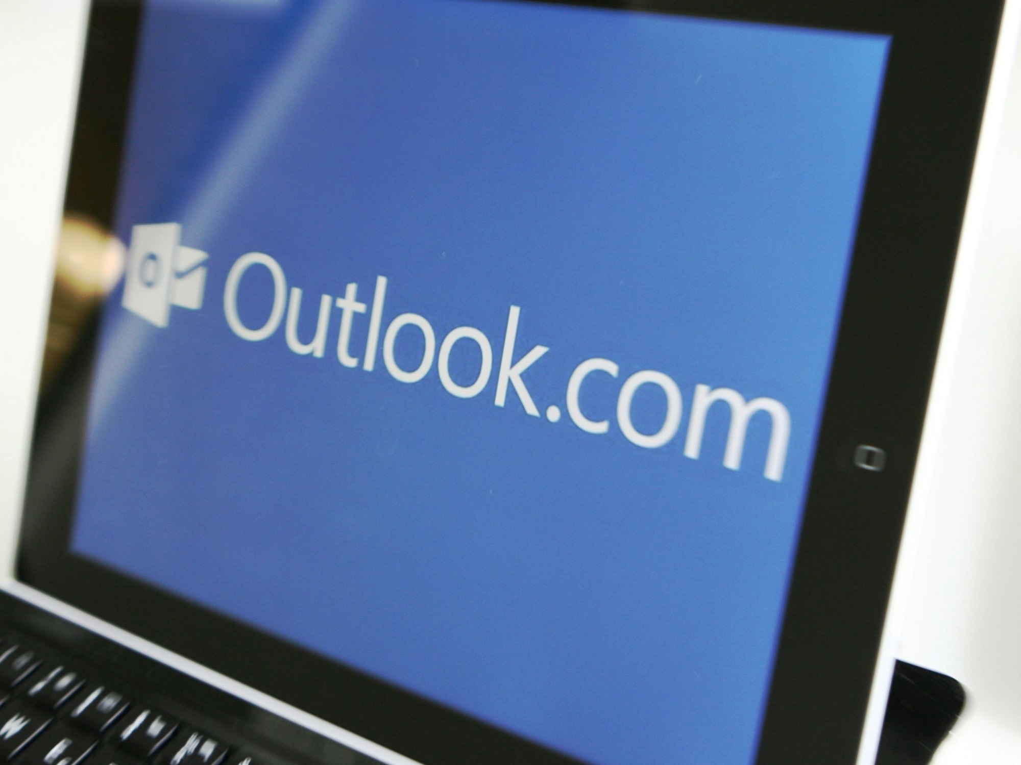 Nutzer in aller Welt meldeten am Samstagabend (1. März) Störungen bei Programmen von Microsoft 365. Das Symbolbild vom Mai 2013 zeigt das Logo des E-Mail-Dienstes auf einem Tablet-Computer.