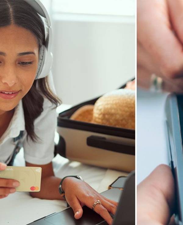 Eine junge Frau liegt auf einem Bett und liest ihre Kreditkarten Nummer von der TF Mastercard Gold ab. Sie tippt auf einer Laptop Tastatur.