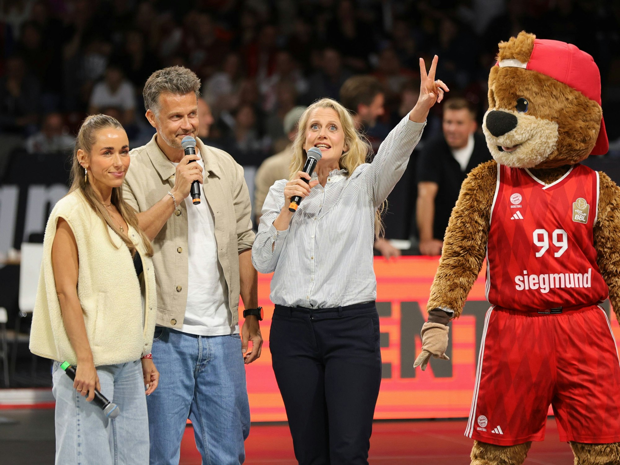Moderatorin Barbara Schöneberger während der Halbzeitpause mit Annemarie und Wayne Carpendale für ihre Sendung „Verstehen Sie Spaß?“