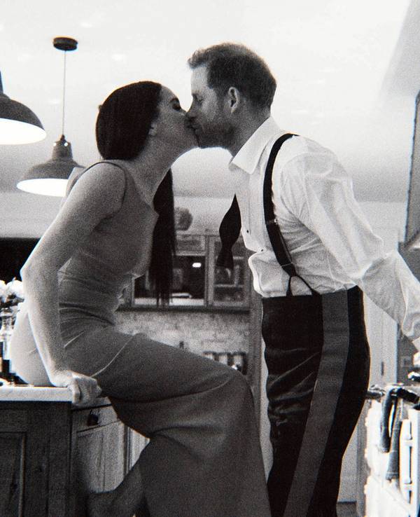 This image released by Netflix shows Prince Harry, right, and Meghan, Duke and Duchess of Sussex, in a scene from the upcoming documentary "Harry & Meghan," directed by Liz Garbus. (Netflix via AP)