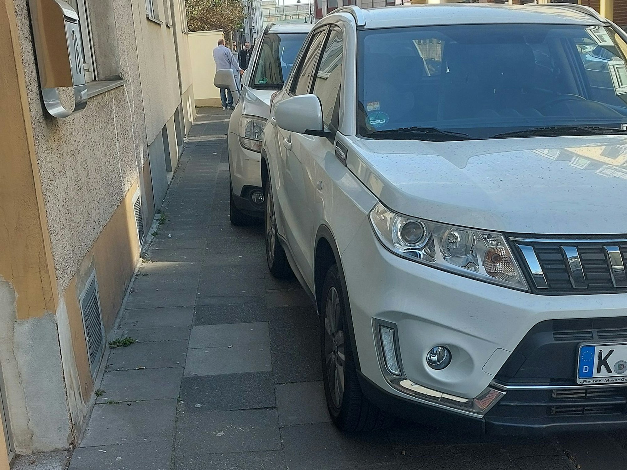 Autos parken auf dem Gehweg.