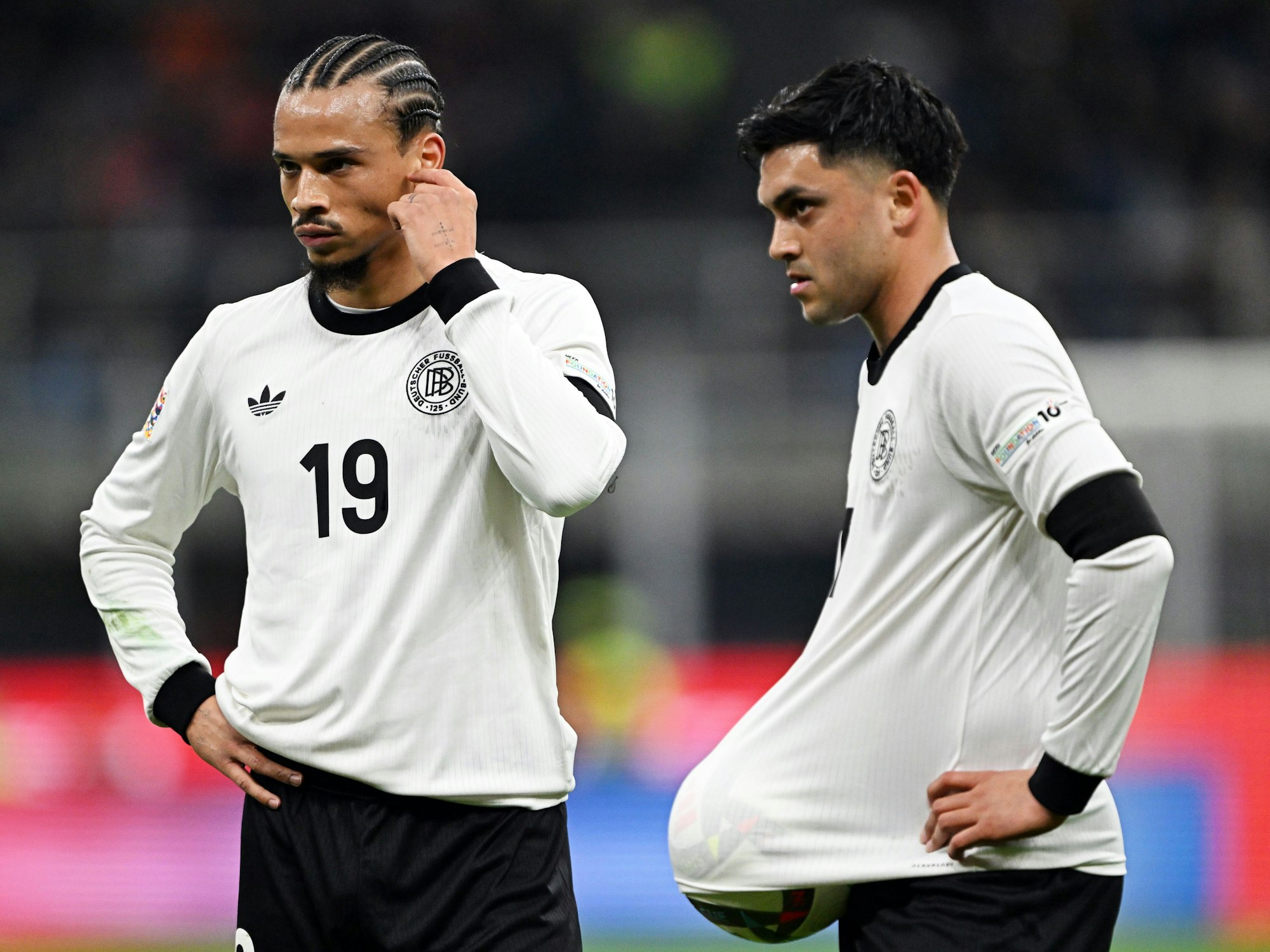 Leroy Sané (l.) und Nadiem Amiri diskutieren auf dem Platz.