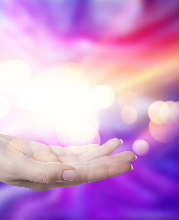 Aura phenomena. Woman with lights of energy coming out from her hand against color background, closeup
