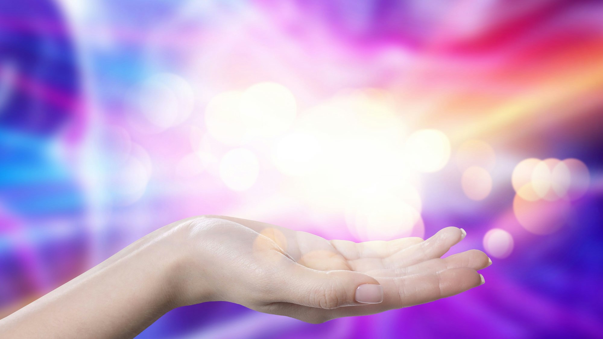 Aura phenomena. Woman with lights of energy coming out from her hand against color background, closeup