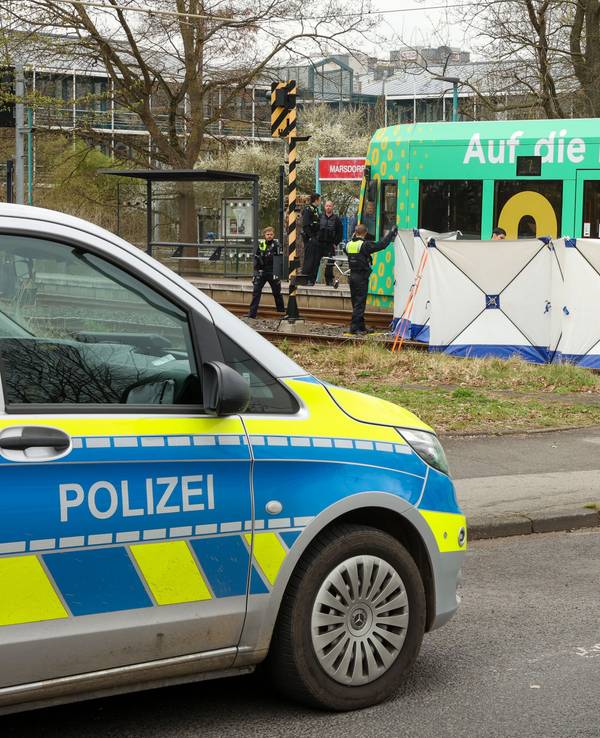 Vor einer stehenden Straßenbahn ist ein Sichtschutz aufgebaut.