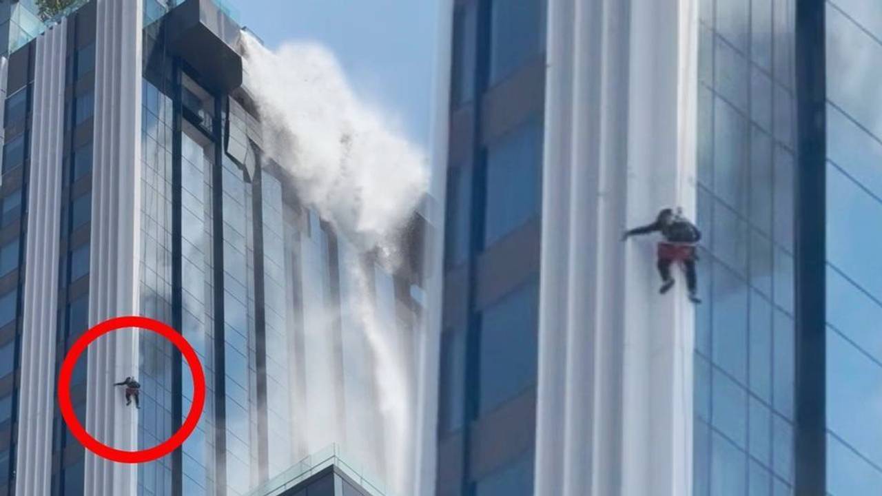 Ein Fensterputzer hängt während des Erdbebens hilflos an einem, Seil an einem Hochhaus in Bangkok.