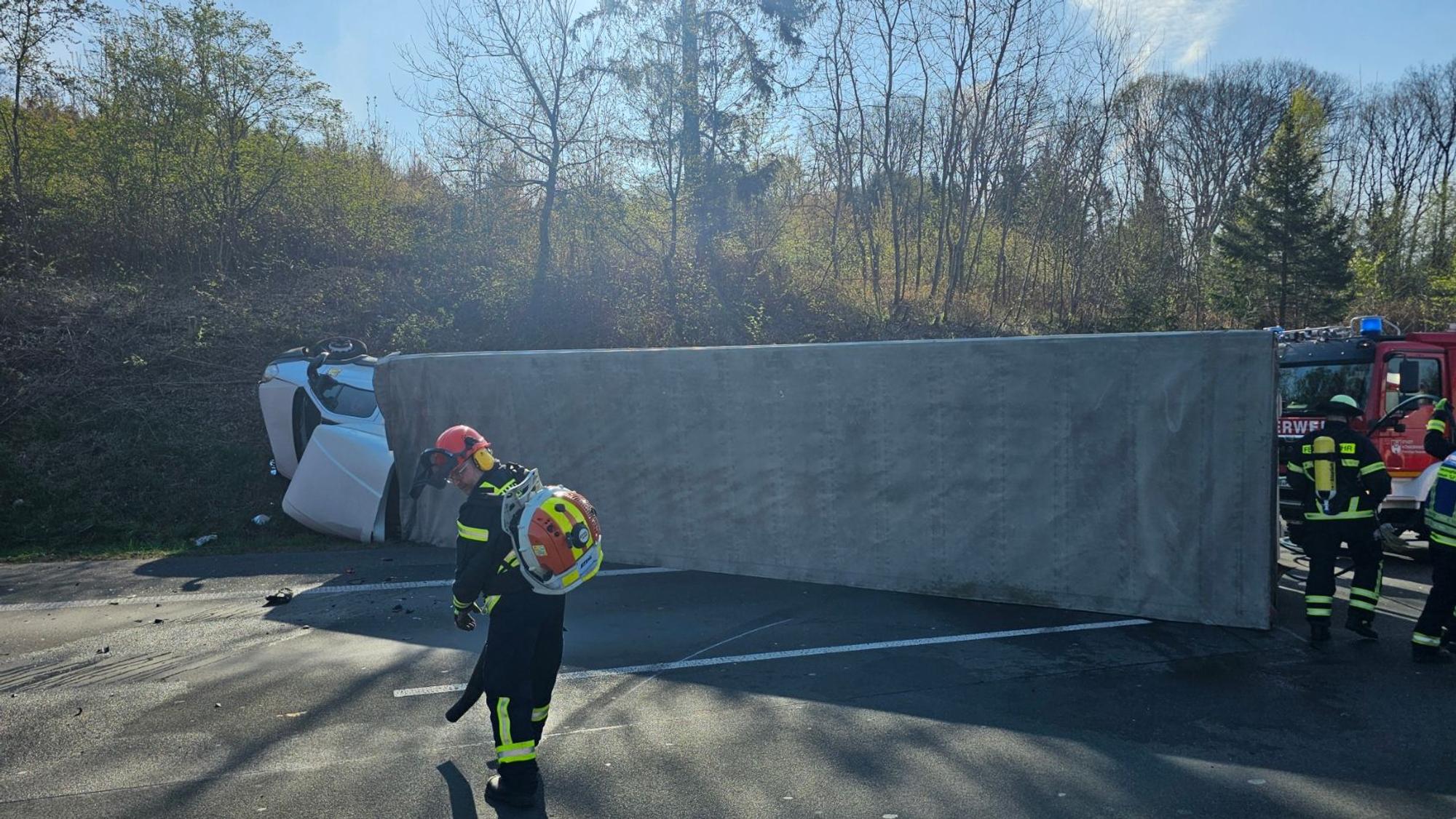Ein umgestürzter Lkw liegt auf der Fahrbahn.