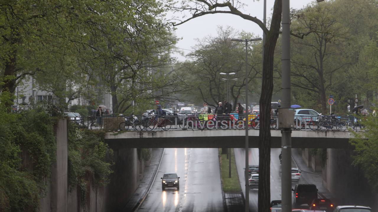 Autos fahren bei Regen durch eine Unterführung.